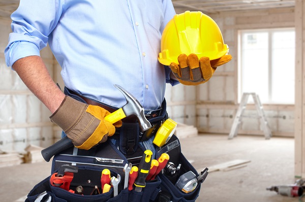 Handyman with a tool belt. House renovation service.